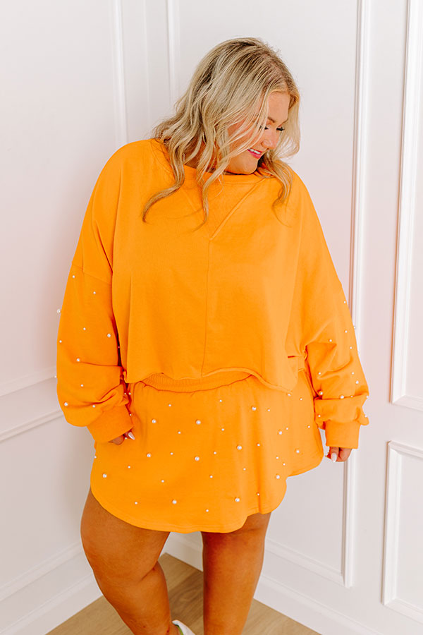 Ultimate Sideline Glam: Pearl Embellished Crop Sweatshirt in Vibrant Orange