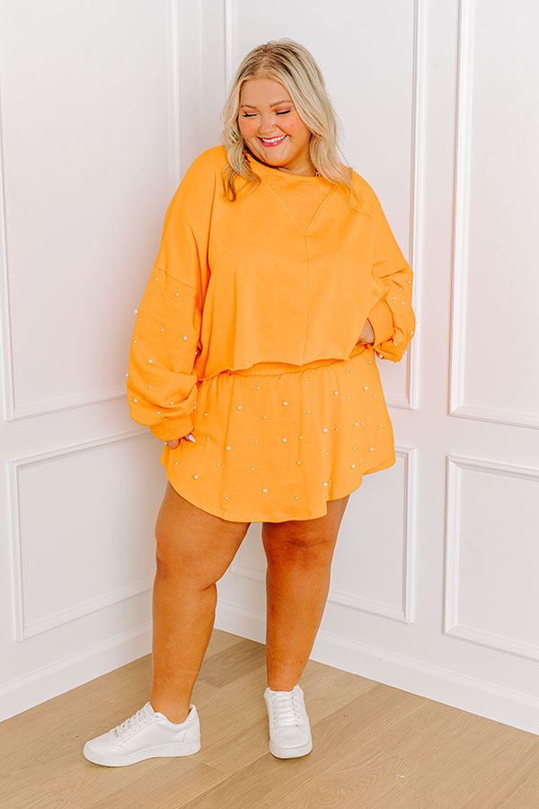 Ultimate Sideline Glam: Pearl Embellished Crop Sweatshirt in Vibrant Orange